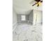 Neutral bedroom with modern marble pattern flooring, double door closet, and a ceiling fan at 1318 W Broad St, Tampa, FL 33604