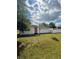 Exterior side view of home showing orange door and well-manicured green lawn and landscaping at 1318 W Broad St, Tampa, FL 33604