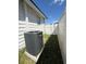 Exterior shot of the side of a house featuring air conditioning unit and vinyl fencing at 1318 W Broad St, Tampa, FL 33604