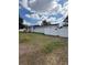Exterior view of property and yard from back of home with fence and small garden space at 1318 W Broad St, Tampa, FL 33604