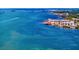 Beautiful aerial view showcasing waterfront buildings and a picturesque coastline in a vibrant waterfront community at 147 & 139 Edgewater Dr, Dunedin, FL 34698