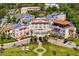 Aerial view of the historic Fenway Hotel featuring a grand entrance, lush landscaping, and manicured lawns at 147 & 139 Edgewater Dr, Dunedin, FL 34698
