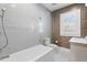 Bathroom with modern soaking tub, glass shower, and white subway tile at 147 & 139 Edgewater Dr, Dunedin, FL 34698