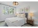 Bright bedroom with lots of natural light, soft bedding and stylish decor at 147 & 139 Edgewater Dr, Dunedin, FL 34698