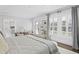 Bright bedroom with white trim, dark floors, large windows, and cozy sitting area at 147 & 139 Edgewater Dr, Dunedin, FL 34698