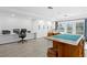 Bright bonus room with white cabinets, recessed lighting, tiled floor, double doors to the outdoors, and office space at 147 & 139 Edgewater Dr, Dunedin, FL 34698