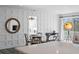 Dining area with modern paneled walls, leading to a bedroom and outdoor balcony at 147 & 139 Edgewater Dr, Dunedin, FL 34698