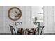 Stylish dining area with a round marble table and wainscoting detail at 147 & 139 Edgewater Dr, Dunedin, FL 34698