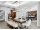An open-concept dining area features a large table, modern lighting, and neutral decor at 147 & 139 Edgewater Dr, Dunedin, FL 34698