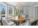 Bright dining room featuring a round table, chandelier, and bay windows, creating an ideal space for gatherings at 147 & 139 Edgewater Dr, Dunedin, FL 34698