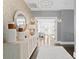 A welcoming entryway with decorative mirror, modern light fixture, and an open view to other rooms at 147 & 139 Edgewater Dr, Dunedin, FL 34698