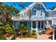 Charming two-story home with lush landscaping, inviting porch, and a second-story balcony at 147 & 139 Edgewater Dr, Dunedin, FL 34698