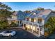 Stunning luxury home with a metal roof, balconies, and a meticulously maintained landscape at 147 & 139 Edgewater Dr, Dunedin, FL 34698