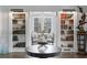 Sophisticated entry showcasing custom bookshelves, and views into dining area, offering a refined sense of style at 147 & 139 Edgewater Dr, Dunedin, FL 34698
