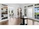 Elegant foyer with hardwood floors, built-in bookshelves, and natural light, creating a warm and inviting entrance at 147 & 139 Edgewater Dr, Dunedin, FL 34698