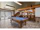 Entertaining in the large game room is easy with a pool table, bar with seating, and an attractive staircase nearby at 147 & 139 Edgewater Dr, Dunedin, FL 34698