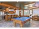 This spacious game room features a pool table and wet bar, perfect for entertaining and relaxation at 147 & 139 Edgewater Dr, Dunedin, FL 34698