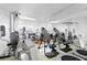 This spacious home gym includes exercise machines, a large mirror, and a trampoline for a complete workout experience at 147 & 139 Edgewater Dr, Dunedin, FL 34698