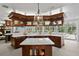 Gourmet kitchen featuring custom cabinets, marble countertops, and high-end appliances perfect for cooking at 147 & 139 Edgewater Dr, Dunedin, FL 34698