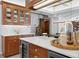 A bright kitchen featuring marble countertops, stainless steel appliances, and custom wood cabinetry at 147 & 139 Edgewater Dr, Dunedin, FL 34698