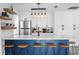Modern kitchen with stainless steel appliances, a blue kitchen island and bar stool seating at 147 & 139 Edgewater Dr, Dunedin, FL 34698