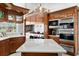 Gourmet kitchen with custom cabinets, marble countertops, and stainless steel appliances perfect for cooking at 147 & 139 Edgewater Dr, Dunedin, FL 34698