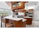 Well-equipped kitchen featuring custom cabinets, marble countertops, and modern appliances for chefs at 147 & 139 Edgewater Dr, Dunedin, FL 34698