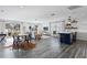 Open-concept living room and kitchen with modern decor and rustic wood floors at 147 & 139 Edgewater Dr, Dunedin, FL 34698