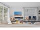 Cozy living space featuring a large window with beach view on the television at 147 & 139 Edgewater Dr, Dunedin, FL 34698