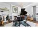 Elegant living room with a grand piano, fireplace, stylish mirror, and exquisite decor, creating a refined ambiance at 147 & 139 Edgewater Dr, Dunedin, FL 34698