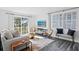 Bright living room with a neutral sofa, accent chairs, and stylish rug at 147 & 139 Edgewater Dr, Dunedin, FL 34698