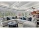 A luxurious living room with large sectional sofa, views of the backyard, and modern decor at 147 & 139 Edgewater Dr, Dunedin, FL 34698