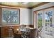 The interior features an attractive window, glass table, and seating that lead to a view of the outdoor space at 147 & 139 Edgewater Dr, Dunedin, FL 34698