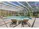 Screened pool with waterfall feature and lounge chairs for relaxing at 147 & 139 Edgewater Dr, Dunedin, FL 34698