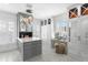Spacious walk-in closet with custom cabinets, island, marble countertop and chandelier at 147 & 139 Edgewater Dr, Dunedin, FL 34698
