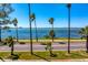 Breathtaking water view framed by palm trees along the scenic road at 147 & 139 Edgewater Dr, Dunedin, FL 34698