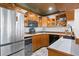 The wet bar offers stainless steel appliances, cabinets with glassware, and a countertop with a sink and wine cooler at 147 & 139 Edgewater Dr, Dunedin, FL 34698