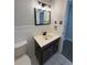 Bathroom featuring a vanity with a mirror, decorative light fixture, and neutral wall color at 1504 Swilley Rd, Plant City, FL 33567