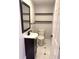 Powder room featuring a modern vanity with shelves and a decorative mirror at 1504 Swilley Rd, Plant City, FL 33567
