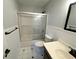 Full bathroom featuring a shower-tub combination with sliding glass doors and updated sink at 1504 Swilley Rd, Plant City, FL 33567