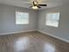 Bedroom featuring two windows, wood floors, and neutral walls at 1504 Swilley Rd, Plant City, FL 33567