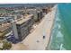 Amazing aerial view of beachfront condos on a white sand beach with clear turquoise water and blue skies at 15462 Gulf Blvd # 504, Madeira Beach, FL 33708