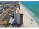 Incredible aerial view of beachfront condos on a white sand beach with clear turquoise water and blue skies at 15462 Gulf Blvd # 504, Madeira Beach, FL 33708