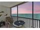 Enjoy the ocean view from this condo balcony featuring a table and chairs at 15462 Gulf Blvd # 504, Madeira Beach, FL 33708