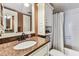 The bathroom has granite counters, stylish lighting, and a shower-tub combination at 15462 Gulf Blvd # 504, Madeira Beach, FL 33708