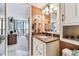 A bathroom with a granite countertop and views of the bedroom and the ocean view from the bedroom at 15462 Gulf Blvd # 504, Madeira Beach, FL 33708