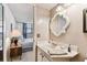 Bathroom with a vanity, decorative mirror and access to the adjacent bedroom at 15462 Gulf Blvd # 504, Madeira Beach, FL 33708