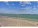 A screened window offers a clear view of the beach and ocean at 15462 Gulf Blvd # 504, Madeira Beach, FL 33708