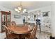 Dining area featuring a wooden table and chairs, and an adjacent kitchen with a breakfast bar at 15462 Gulf Blvd # 504, Madeira Beach, FL 33708