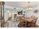 Dining area featuring an adjacent kitchen and breakfast bar, features a rustic wood table at 15462 Gulf Blvd # 504, Madeira Beach, FL 33708
